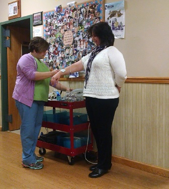 Dr. Kim Somjen, DVM demonstrates electrical stimulation unit at Open House