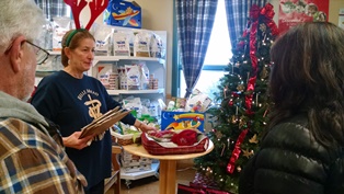 Helene explains raffles to visitors at Belle Mead Animal Hospital 2014 Open House and Reindeer event